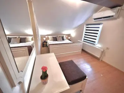 a small room with two beds and a window at International Inn in Paraćin
