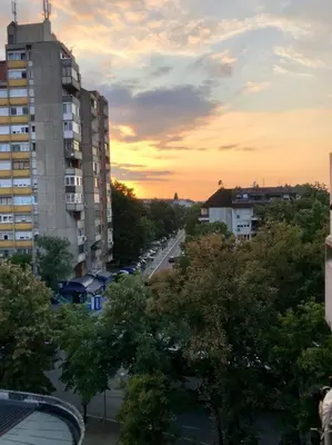a view of a city street with trees and buildings at Lovely 1-bedroom condo with available parking in Kraljevo