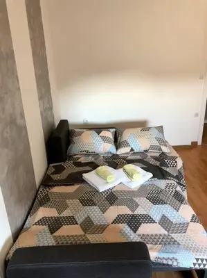 a bed with two pillows on top of it at Lovely 1-bedroom condo with available parking in Kraljevo