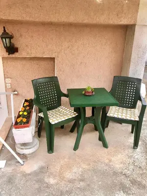 two green chairs and a green table and chairs at Apartman TADIJA Niš in Donja Vrežina
