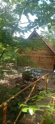 a wooden cabin with a fence in front of it at Vila Golija in Raška