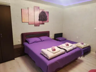 a bedroom with two beds with towels on them at Centrum Lux Apartment in Niš