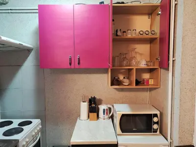 a pink cabinet in a kitchen with a microwave at Centrum Lux Apartment in Niš