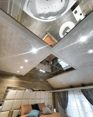a ceiling in a room with a bed and a couch at Apartman OGLEDALO in Zaječar