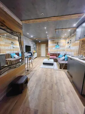 a large room with a kitchen and a living room at Apartman OGLEDALO in Zaječar