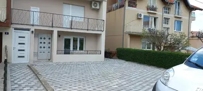 a white car parked in front of a building at Apartman Vista Sokobanja in Soko Banja