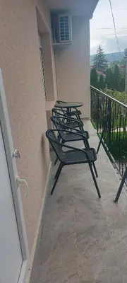a row of chairs sitting on a balcony at Apartman Vista Sokobanja in Soko Banja