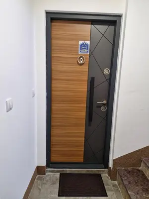 a wooden door in a building with a sign on it at Apartman Vista Sokobanja in Soko Banja