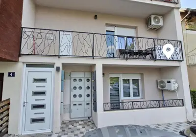 a house with a balcony with a table on it at Apartman Vista Sokobanja in Soko Banja