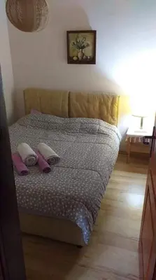 a bed with two pillows on it in a room at Apartmani Damjan Vlasinsko jezero in Surdulica