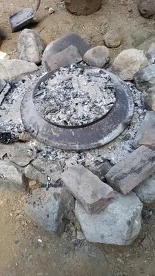 a fire pit with a circle of rubble and rocks at Apartmani Damjan Vlasinsko jezero in Surdulica