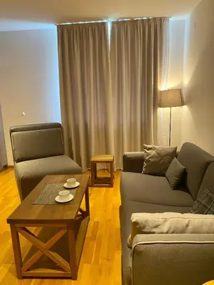 a living room with two couches and a coffee table at Apartman 20, Brzeće Centar in Brzeće