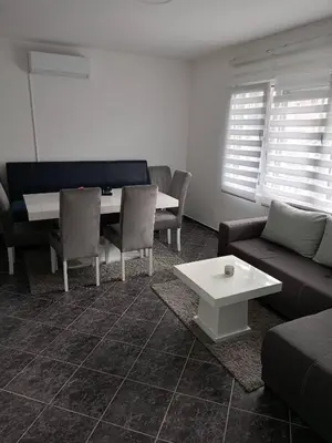 a living room with a couch and a table at Gostinska kuća in Leskovac