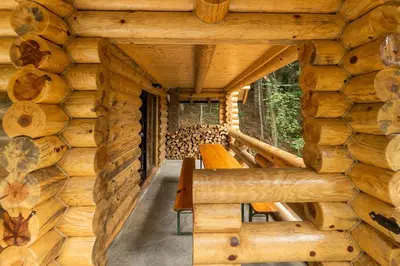 a log cabin with wooden walls and benches at Casa Montana in Kopaonik