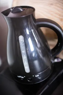 a black coffee pot sitting on top of a stove at Casa Montana in Kopaonik