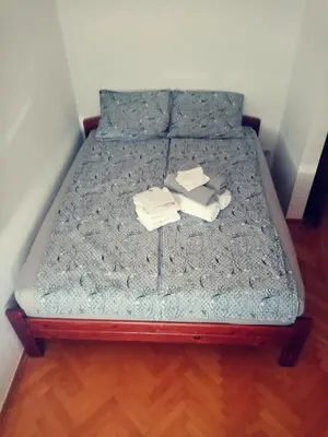 a bed with two books and towels on it at Apartman Simović, Vrnjačka Banja in Vrnjačka Banja