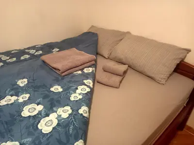 a bed with two pillows on top of it at Apartman Simović, Vrnjačka Banja in Vrnjačka Banja