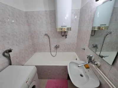 a bathroom with a sink and a tub and a toilet at CENTRAL in Kruševac