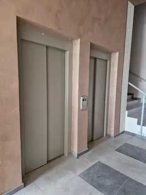 a row of elevator doors in a building at apartman TARA aqua park in Jagodina