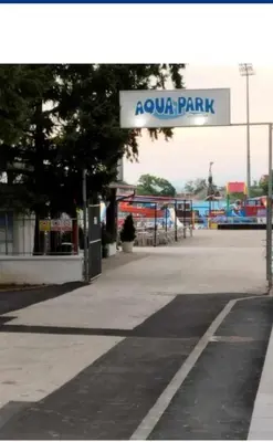 a park with a sign that reads aqua park at apartman TARA aqua park in Jagodina