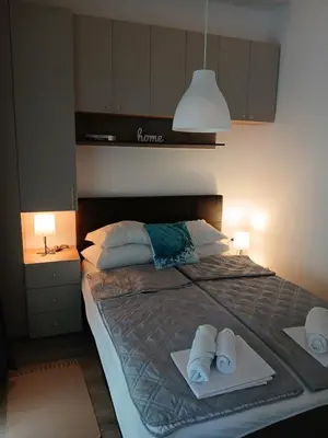 a bedroom with a bed with towels on it at apartman TARA aqua park in Jagodina