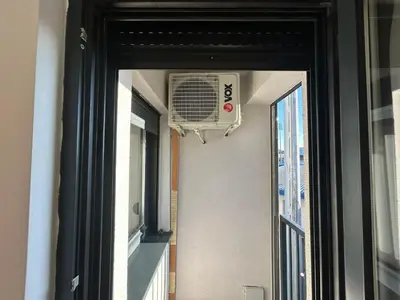 a window with a fan on the side of a building at Centar Crnjanski 1 in Jagodina