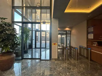 a lobby with glass doors and a potted plant at Centar Crnjanski 1 in Jagodina