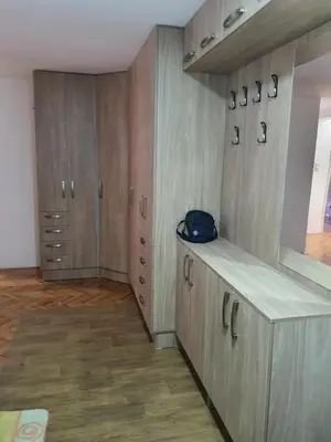 a room with wooden cupboards and a bag on the counter at Big apartman - Free parking in Vranje