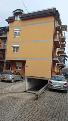 a building with a car parked in front of it at Big apartman - Free parking in Vranje