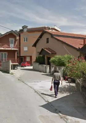 a man walking down a street in a village at Big apartman - Free parking in Vranje