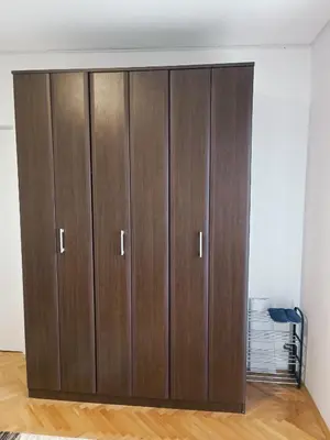 a pair of wooden cabinets in a room at Apartman HeLena in Soko Banja