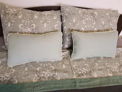 a bed with two pillows and a blanket at Apartman HeLena in Soko Banja