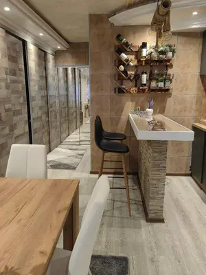 a kitchen with a table and a black chair at Premium Urban Life in Zaječar