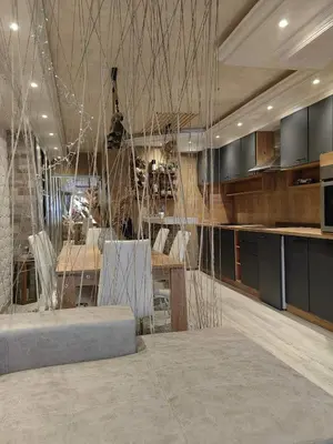 a living room with a table and a kitchen at Premium Urban Life in Zaječar