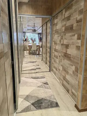 a hallway of a house with wooden walls and glass doors at Premium Urban Life in Zaječar