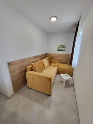a living room with a couch and a table at Vila Pčelica Petra in Soko Banja