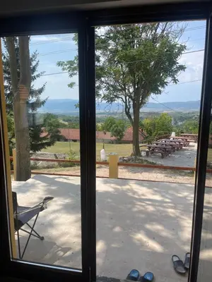 a sliding glass door with a view of a patio at Green House Latin Grad in Vrmdža