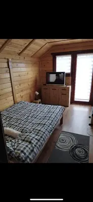 a bedroom with a bed and a tv in a cabin at Green House Latin Grad in Vrmdža