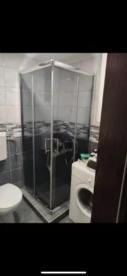 a shower in a bathroom with a washing machine at Green House Latin Grad in Vrmdža