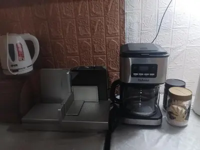 a coffeemaker and a coffee maker on a counter at Aleksinac Centar Two-Bedroom Apartment in Aleksinac