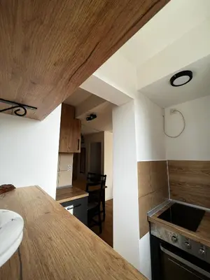 a kitchen with a wooden ceiling and a counter top at Sailboat Apartment in Niš