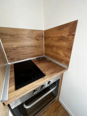 a kitchen with a wooden counter top with a stove at Sailboat Apartment in Niš