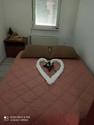 a bedroom with a bed with a heart made out at Mila lux in Niš
