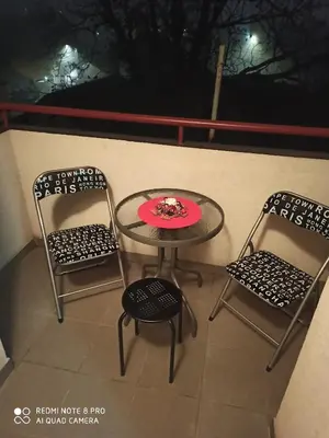 two chairs and a table with a red plate on it at Mila lux in Niš