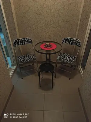 a table and two chairs with a red plate on it at Mila lux in Niš
