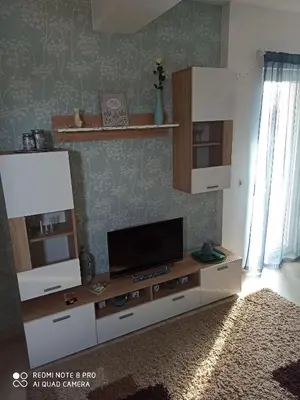 a living room with a flat screen tv on a entertainment center at Mila lux in Niš