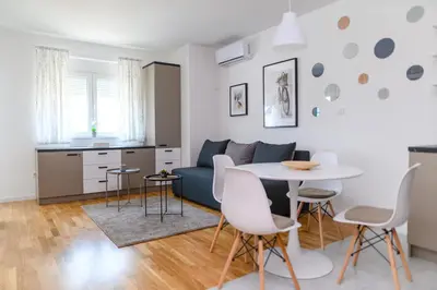 a living room with a table and a couch at AQUA LUX - Green Hill - Kod akva parka Podina in Soko Banja