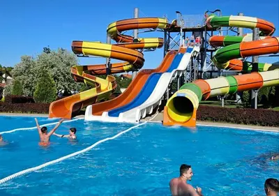 a group of people in a water slide at a water park at AQUA LUX - Green Hill - Kod akva parka Podina in Soko Banja