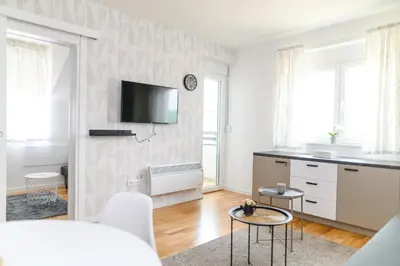 a living room with a tv on a wall at AQUA LUX - Green Hill - Kod akva parka Podina in Soko Banja