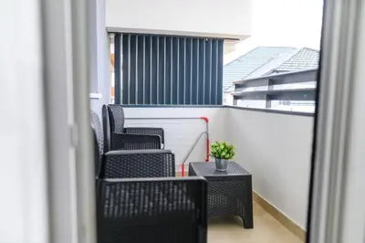 a balcony with two chairs and a table at AQUA LUX - Green Hill - Kod akva parka Podina in Soko Banja